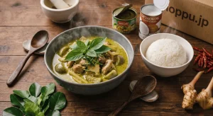 Bowl of Thai green curry with chicken basil and jasmine rice on wooden table with shoppu.jp ingredients 1